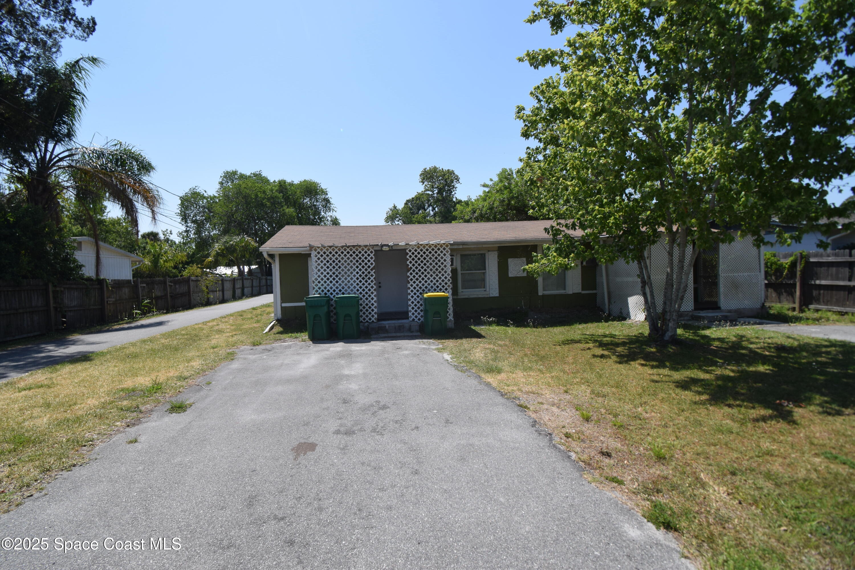 329 Pine Avenue, Unit E Cocoa, FL 32922 - Photo 11 of 11 a front view of a house with a yard and a garage