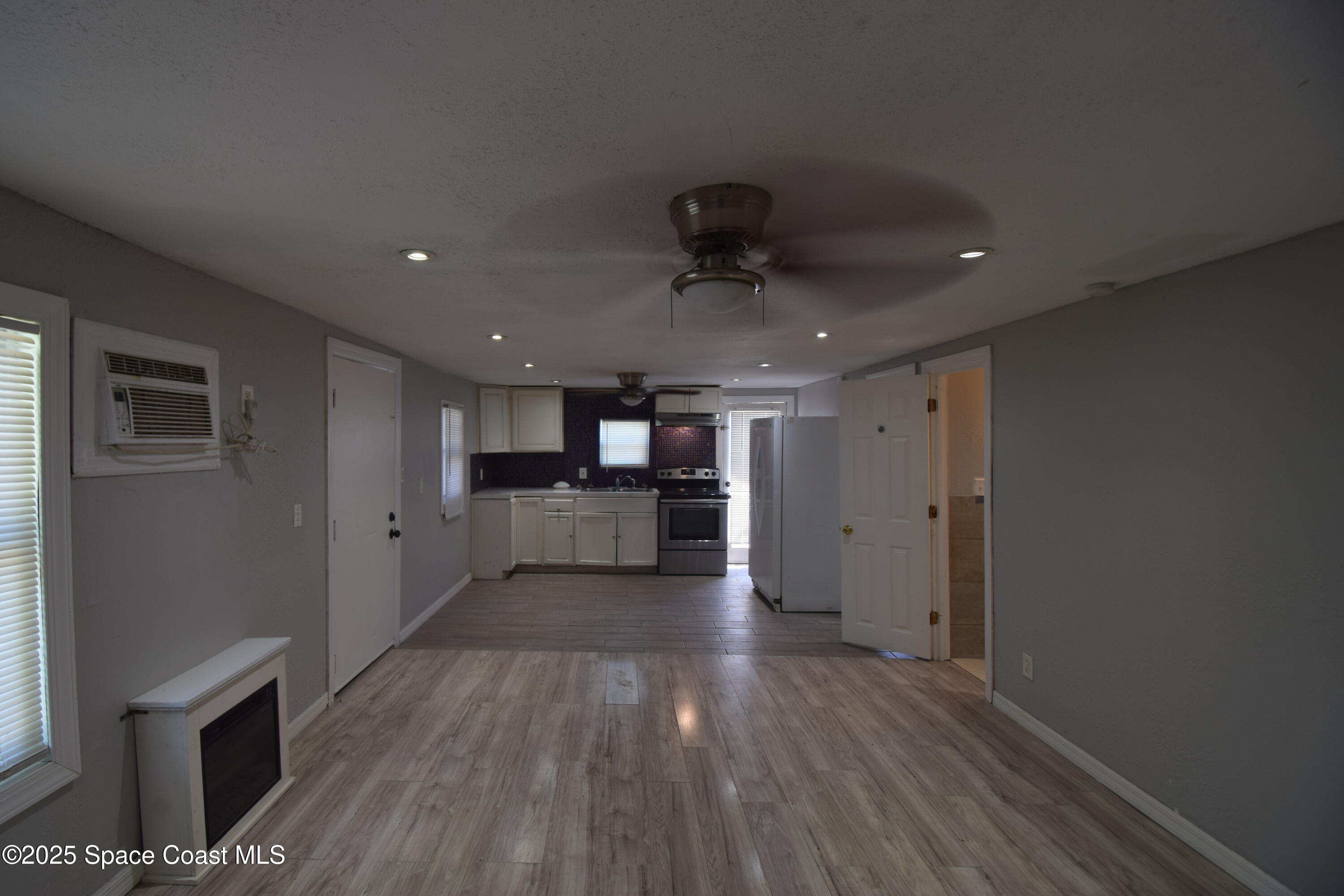 329 Pine Avenue, Unit E Cocoa, FL 32922 - Photo 3 of 11 a view of a kitchen with a sink and a refrigerator