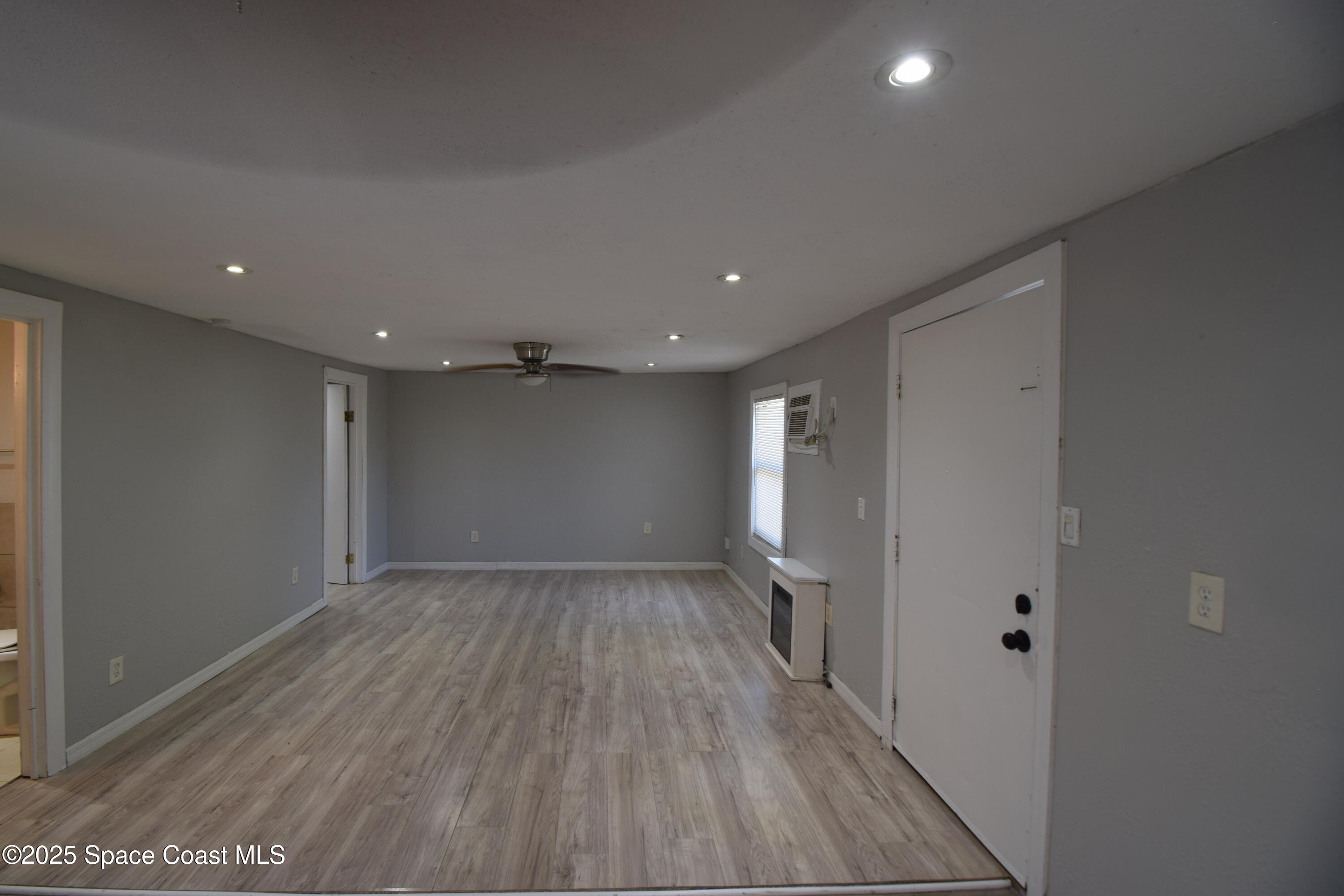 329 Pine Avenue, Unit E Cocoa, FL 32922 - Photo 6 of 11 a view of hallway with wooden floor