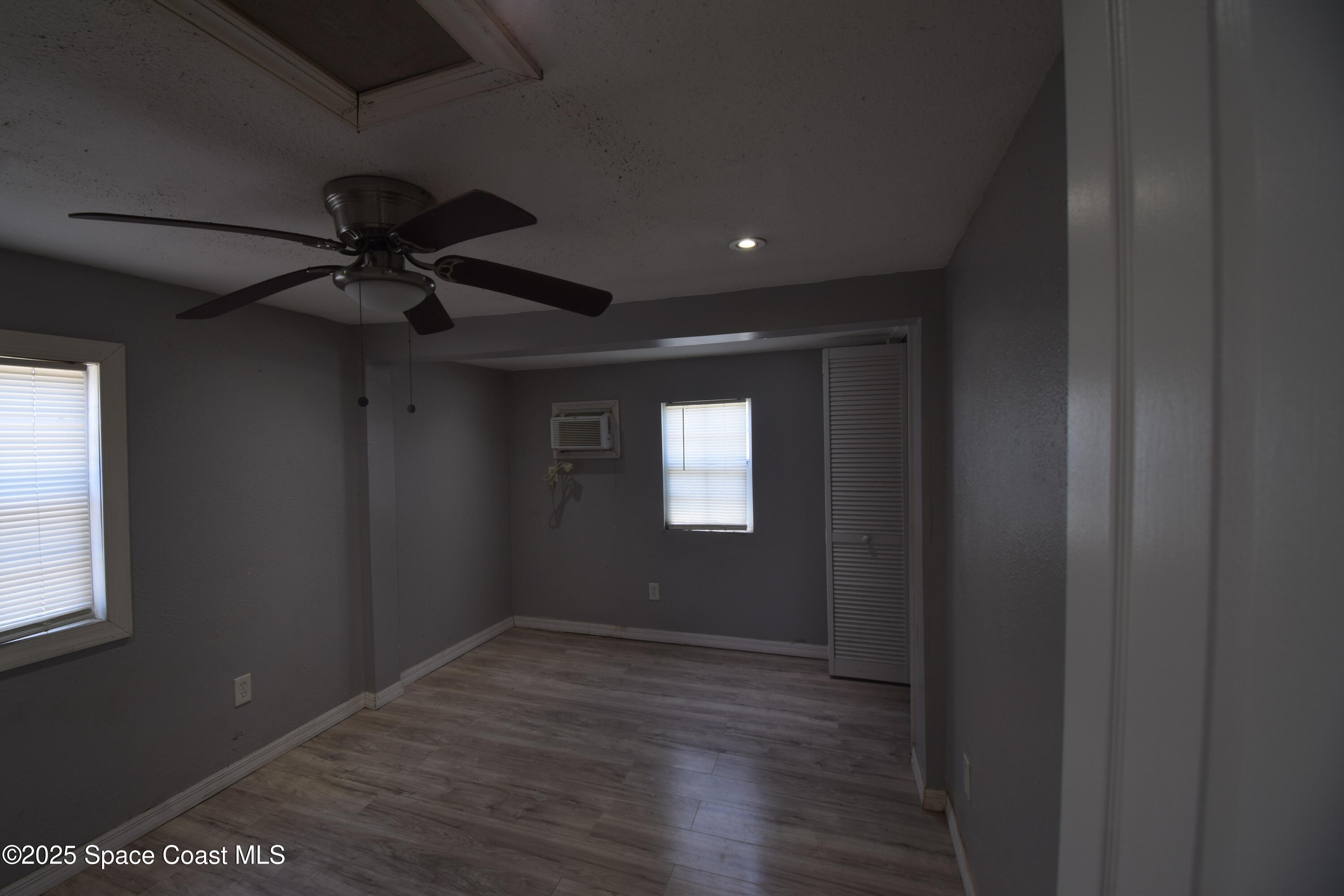 329 Pine Avenue, Unit E Cocoa, FL 32922 - Photo 7 of 11 a view of a livingroom with a ceiling fan and window