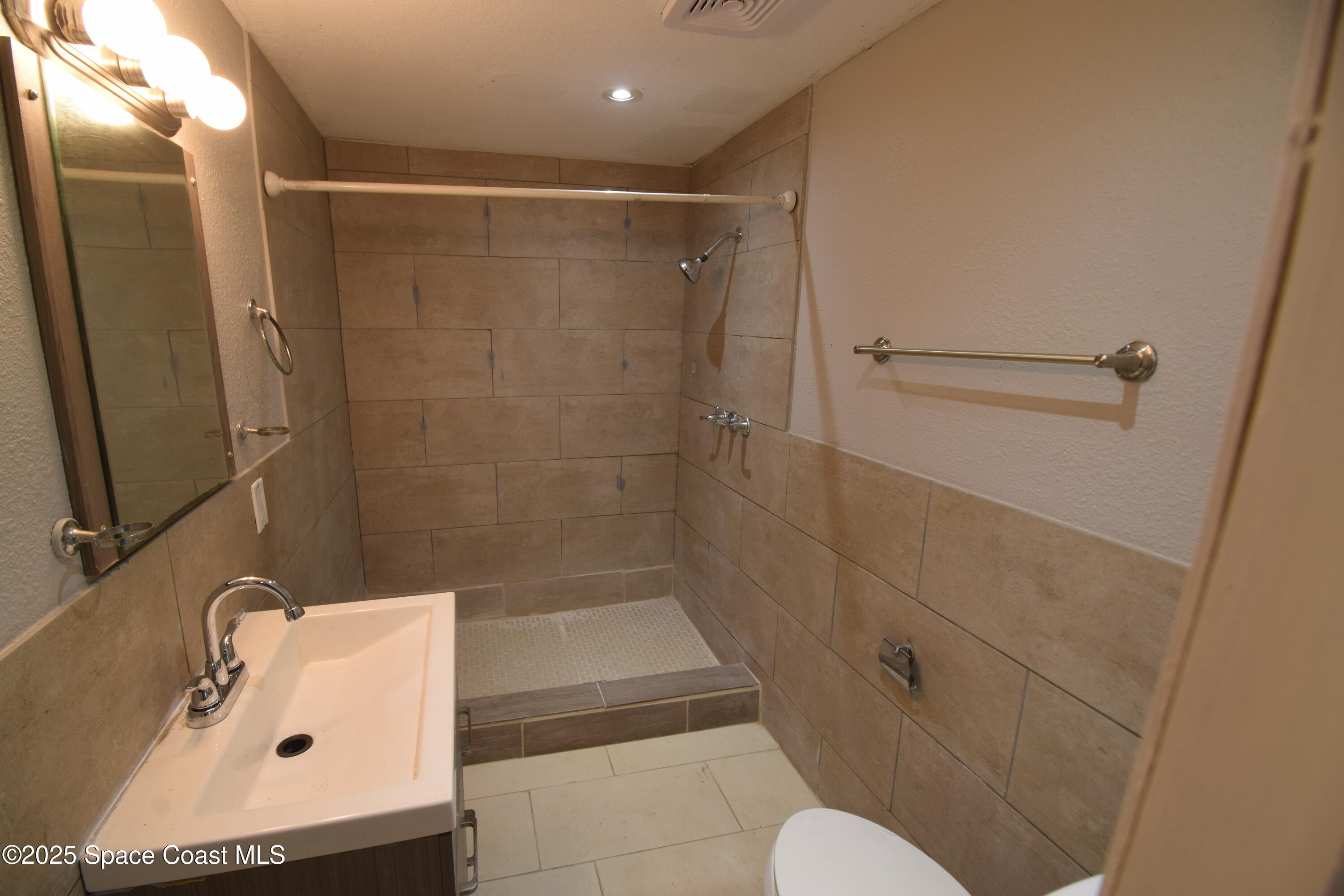 329 Pine Avenue, Unit E Cocoa, FL 32922 - Photo 8 of 11 a bathroom with a shower