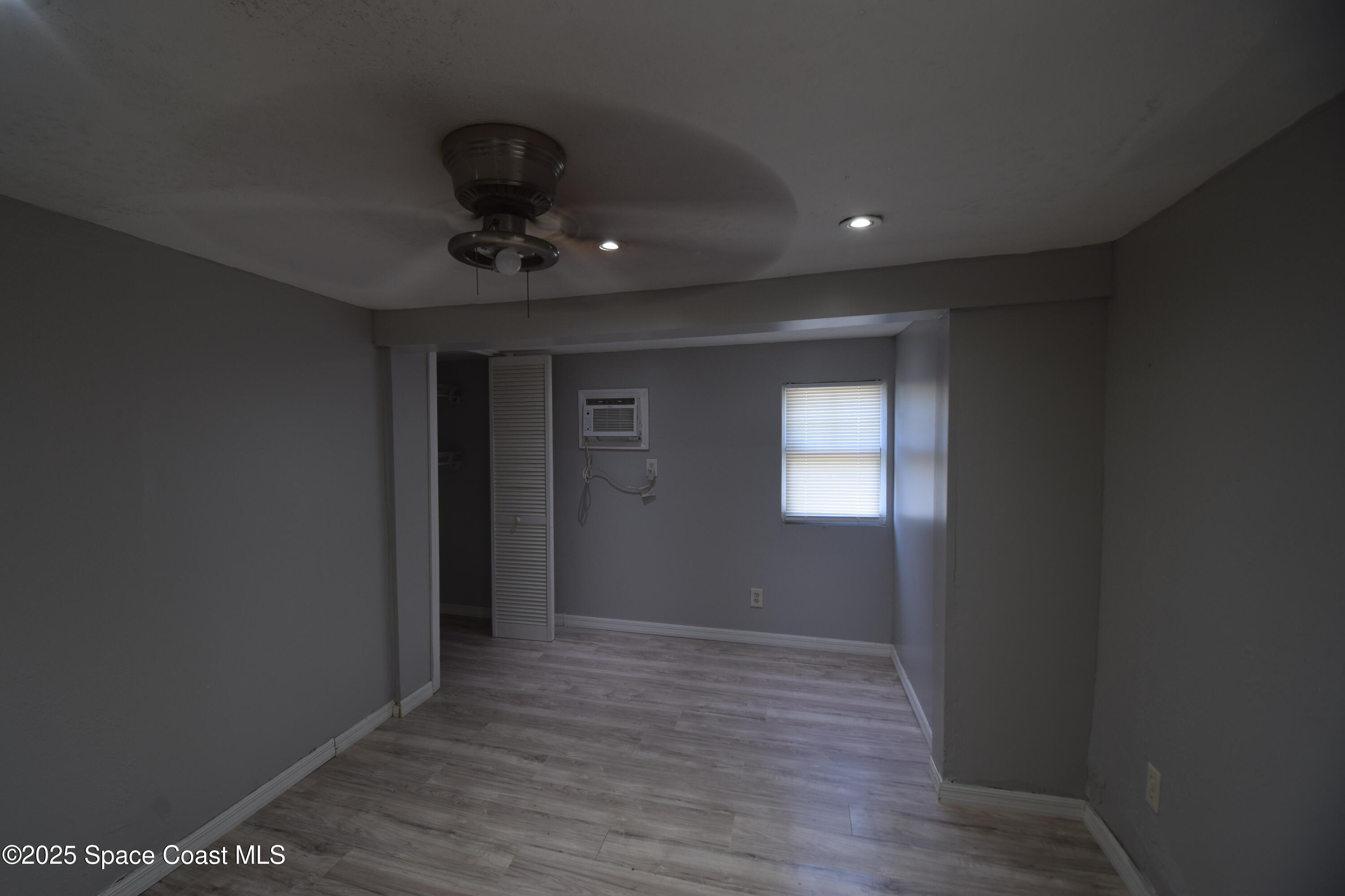 329 Pine Avenue, Unit E Cocoa, FL 32922 - Photo 9 of 11 a view of an empty room with a window