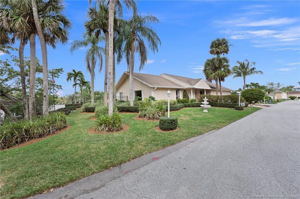 815 Southwest Salerno Road Stuart, FL 34997 - Photo 20 of 71 a front view of a house with garden