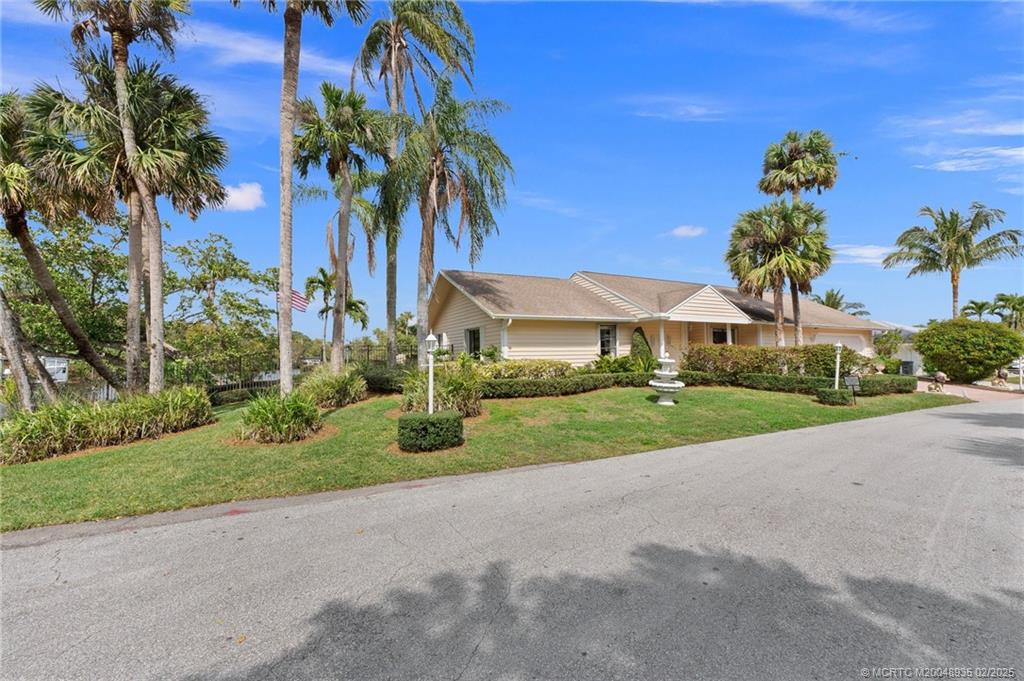815 Southwest Salerno Road Stuart, FL 34997 - Photo 22 of 71 a front view of a house with garden