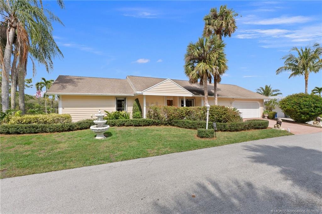 815 Southwest Salerno Road Stuart, FL 34997 - Photo 23 of 71 a front view of a house with garden