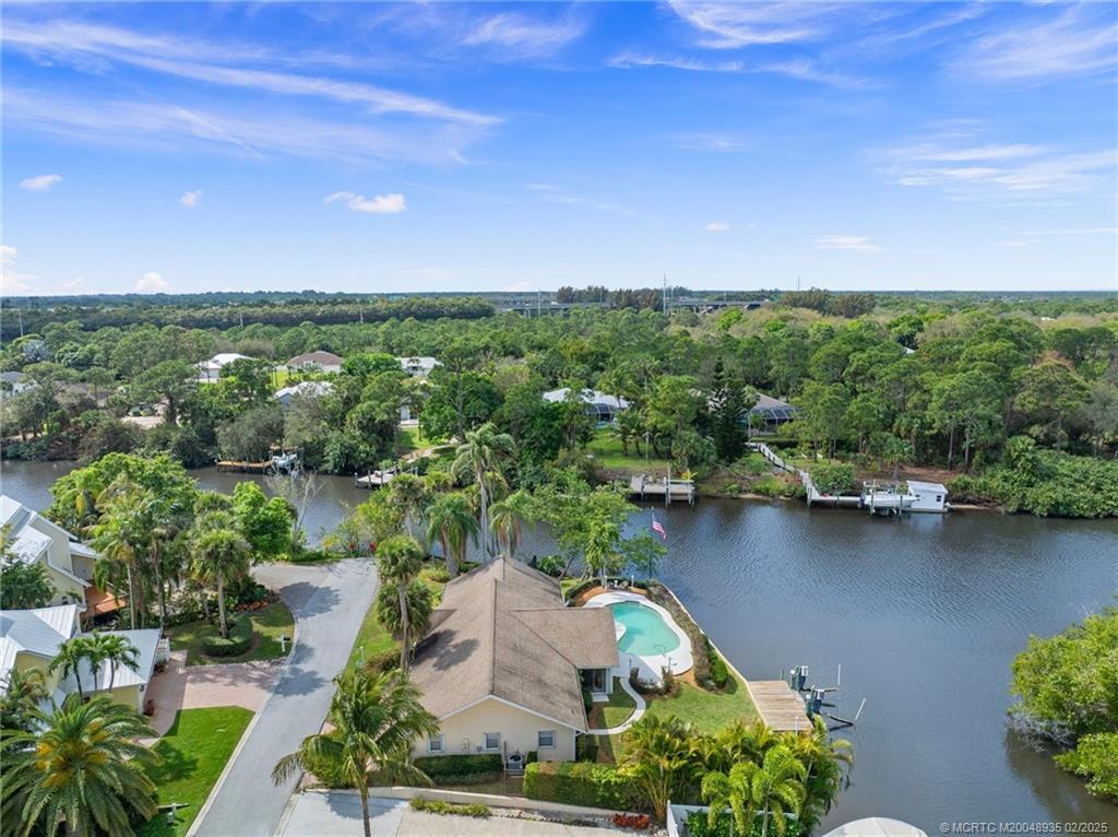 815 Southwest Salerno Road Stuart, FL 34997 - Photo 3 of 71 an aerial view of lake residential house with outdoor space and trees around