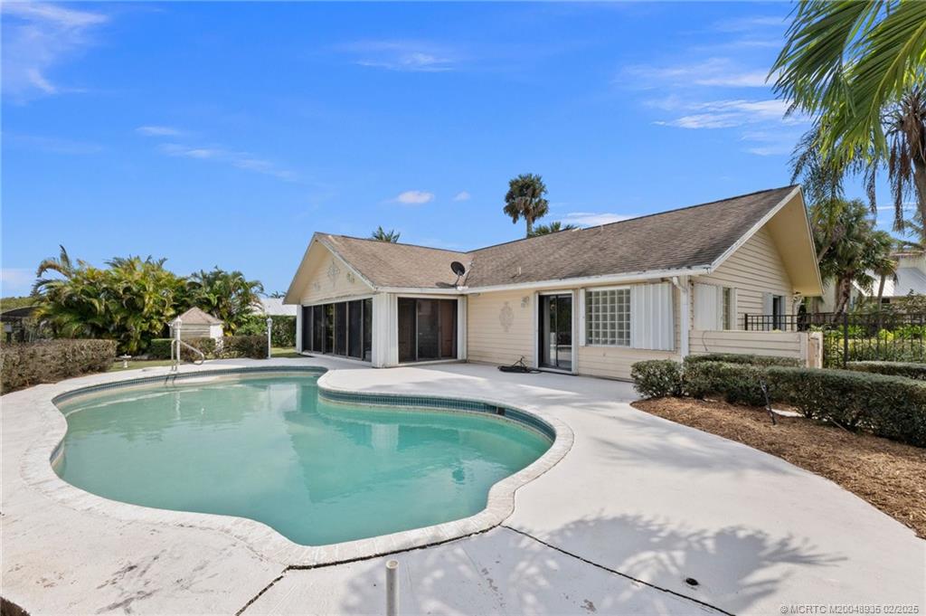 815 Southwest Salerno Road Stuart, FL 34997 - Photo 31 of 71 a view of a house with swimming pool and a yard