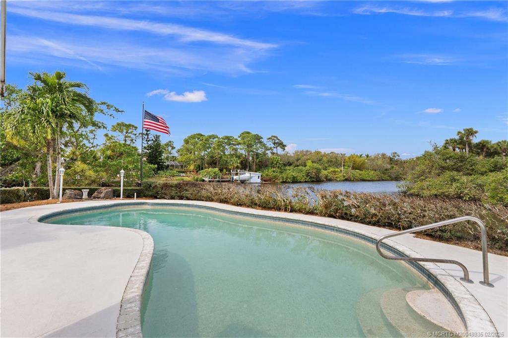 815 Southwest Salerno Road Stuart, FL 34997 - Photo 33 of 71 a view of a lake with a yard