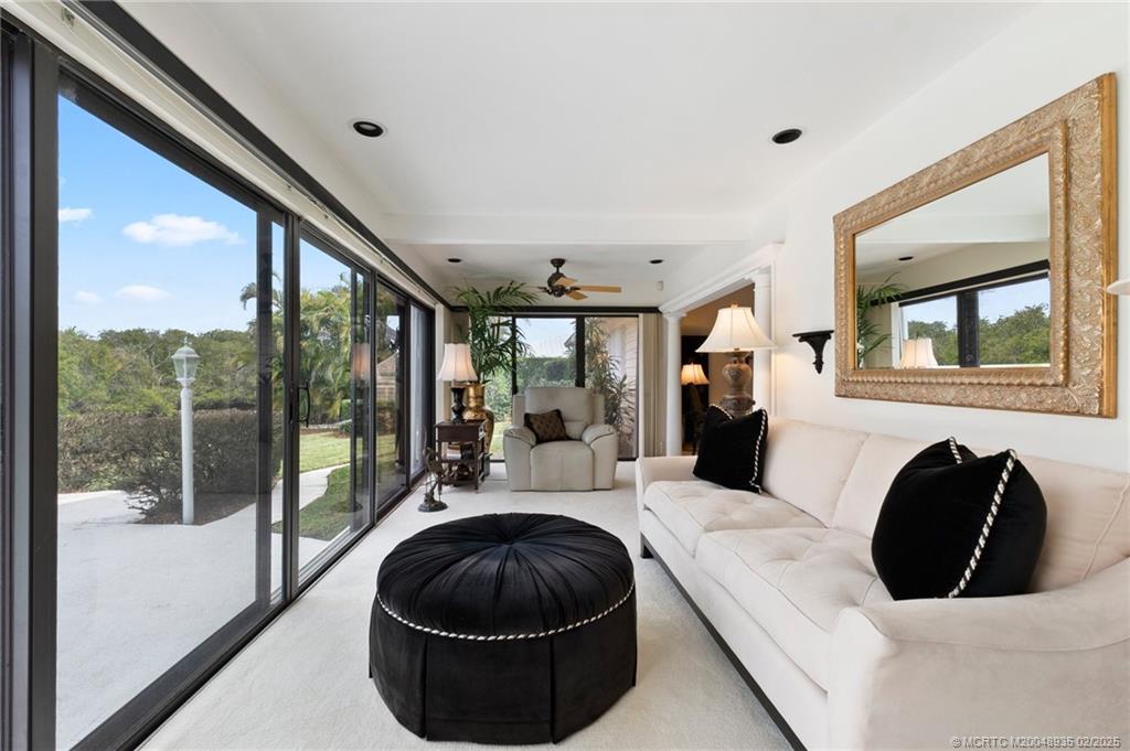 815 Southwest Salerno Road Stuart, FL 34997 - Photo 40 of 71 a living room with furniture and a large window