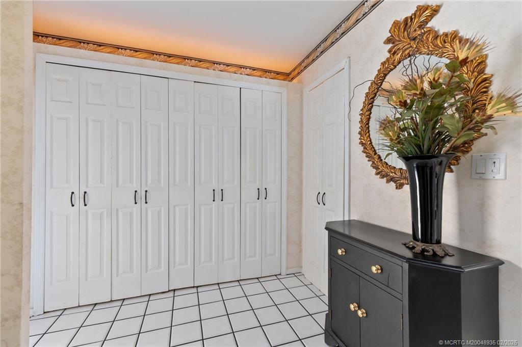 815 Southwest Salerno Road Stuart, FL 34997 - Photo 49 of 71 a close view of a sink a mirror and a shower curtain