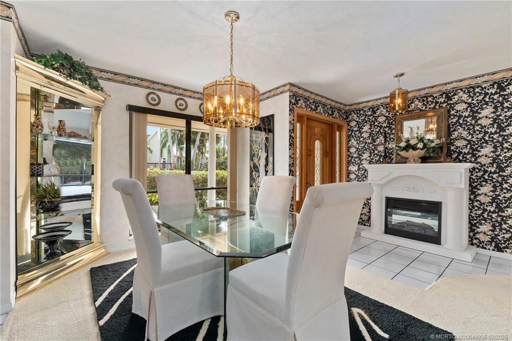 815 Southwest Salerno Road Stuart, FL 34997 - Photo 53 of 71 a view of a dining room with furniture window and wooden floor