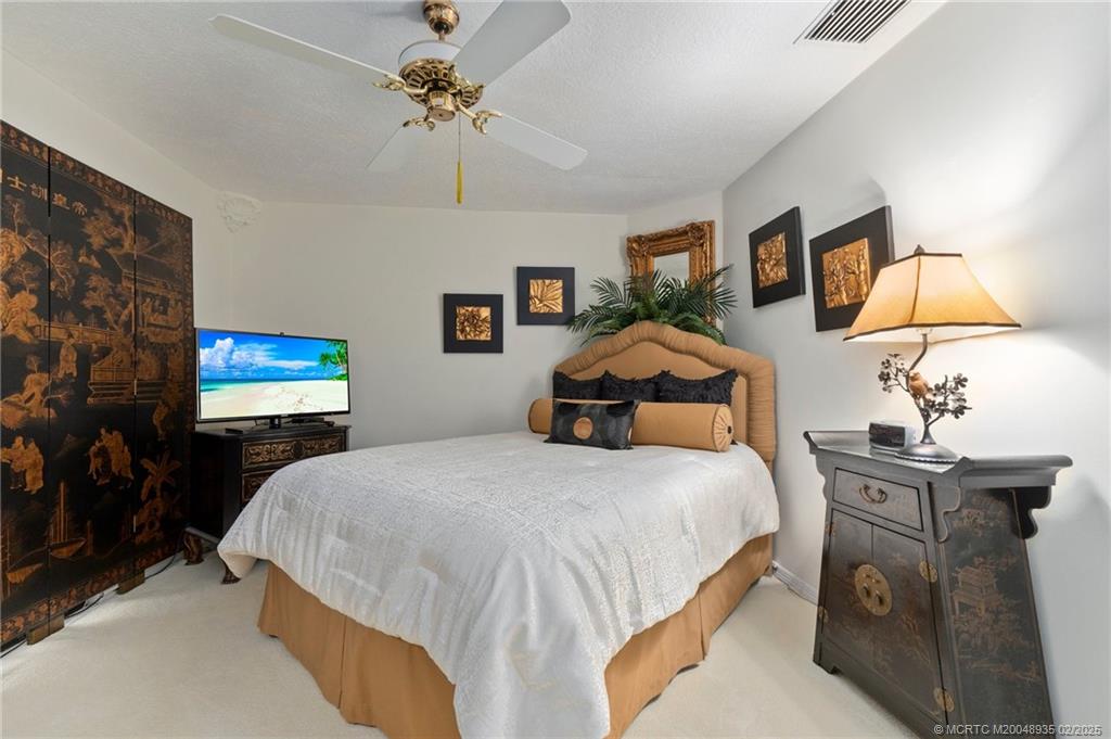 815 Southwest Salerno Road Stuart, FL 34997 - Photo 58 of 71 a bedroom with a bed and a flat screen tv