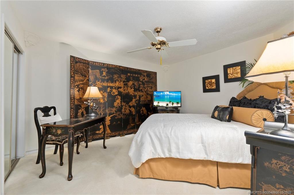 815 Southwest Salerno Road Stuart, FL 34997 - Photo 59 of 71 a bedroom with a bed and a window