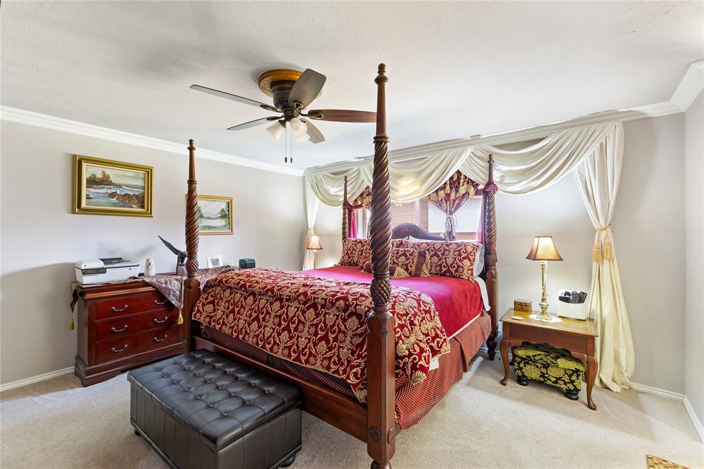 2402 Scott Mill Road Carrollton, TX 75006 - Photo 11 of 20 a bedroom with a bed a dresser and window