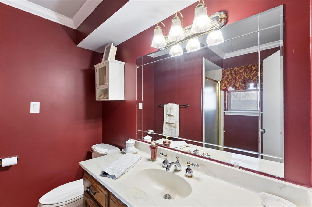 2402 Scott Mill Road Carrollton, TX 75006 - Photo 13 of 20 a bathroom with a sink vanity mirror and toilet