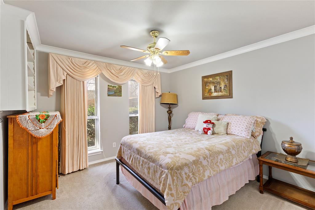 2402 Scott Mill Road Carrollton, TX 75006 - Photo 15 of 20 a bedroom with bed and wooden floor