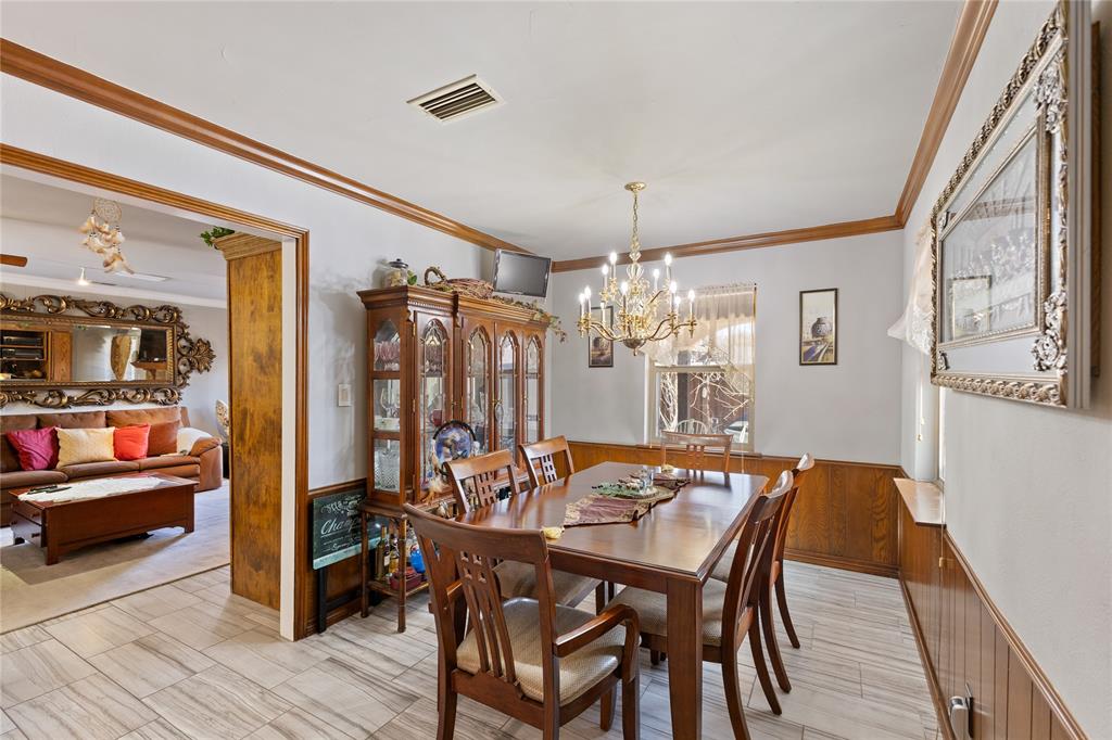 2402 Scott Mill Road Carrollton, TX 75006 - Photo 9 of 20 a view of a dining room with furniture and wooden floor