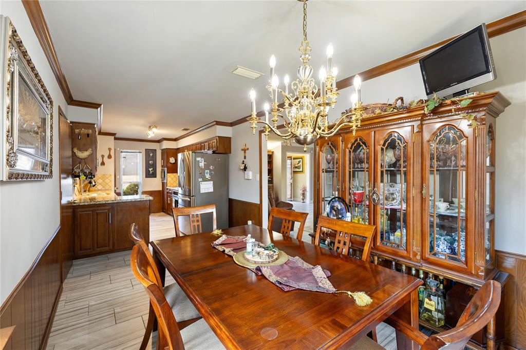 2402 Scott Mill Road Carrollton, TX 75006 - Photo 10 of 20 a view of a dining room with furniture and chandelier