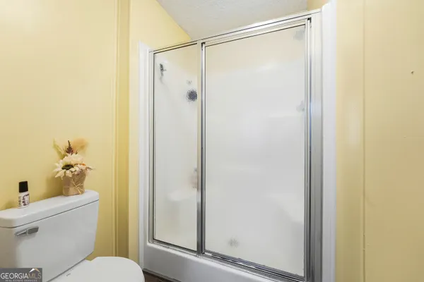 a bathroom with a shower and a toilet