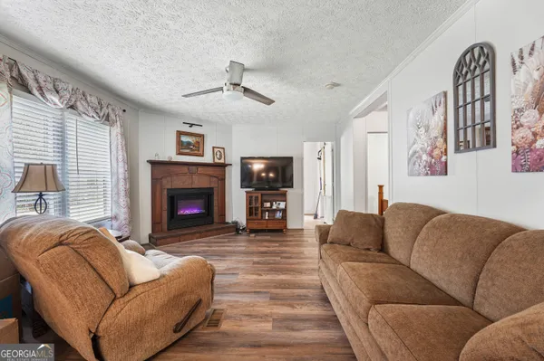 a living room with furniture a flat screen tv and a fireplace