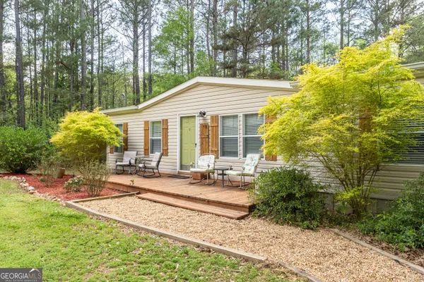 a backyard of a house with yard and outdoor seating