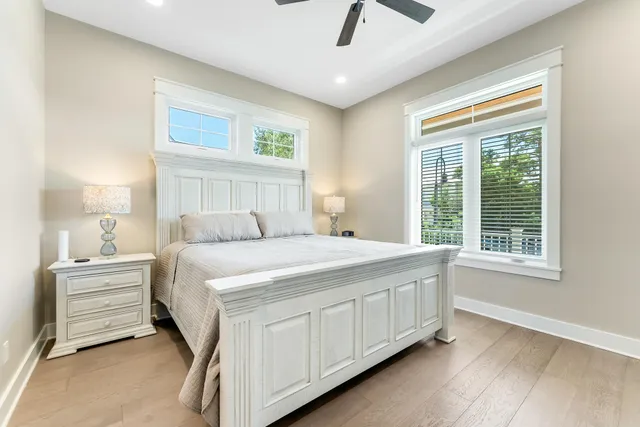 a bedroom with a bed chandelier and a window