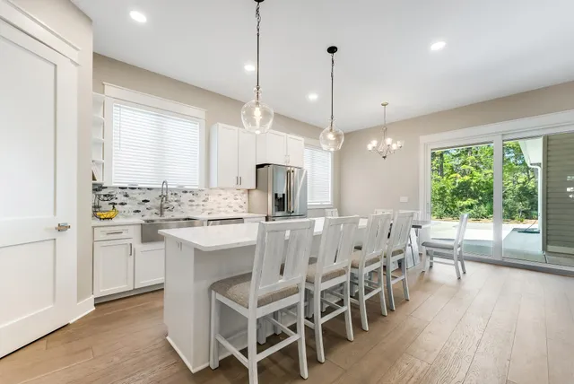 a large kitchen with a table and chairs