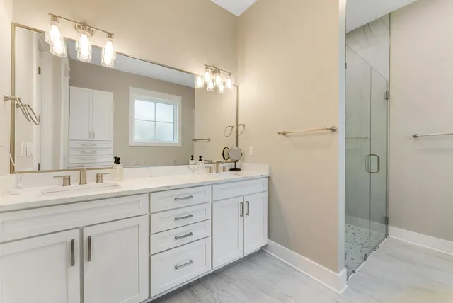 a bathroom with double sink and a mirror