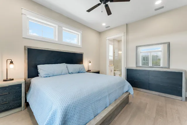 a bedroom with a large bed and a chandelier