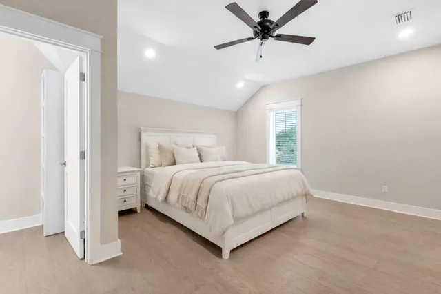 a bedroom with a bed and a ceiling fan