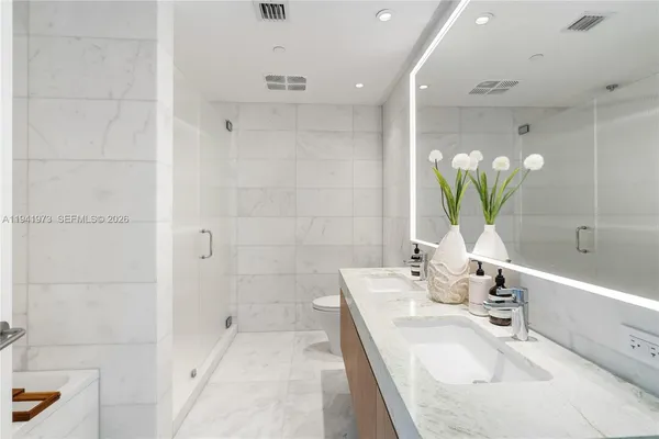 a large bedroom with a large bed and a large window with outer view