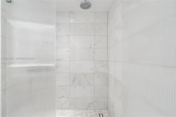 a spacious bedroom with a large bed and a large window