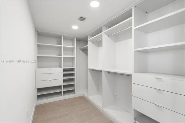 a large kitchen with stainless steel appliances granite countertop a granite counter tops and a view of living room