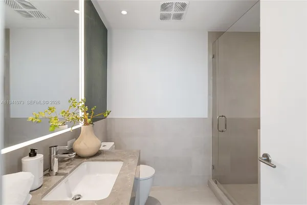 a bathroom with a glass shower door