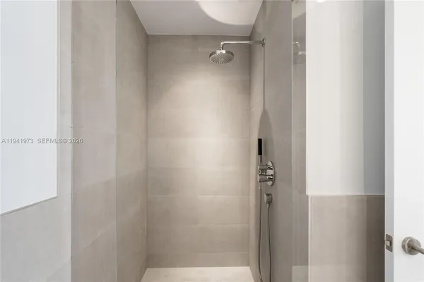 a bathroom with a glass shower door