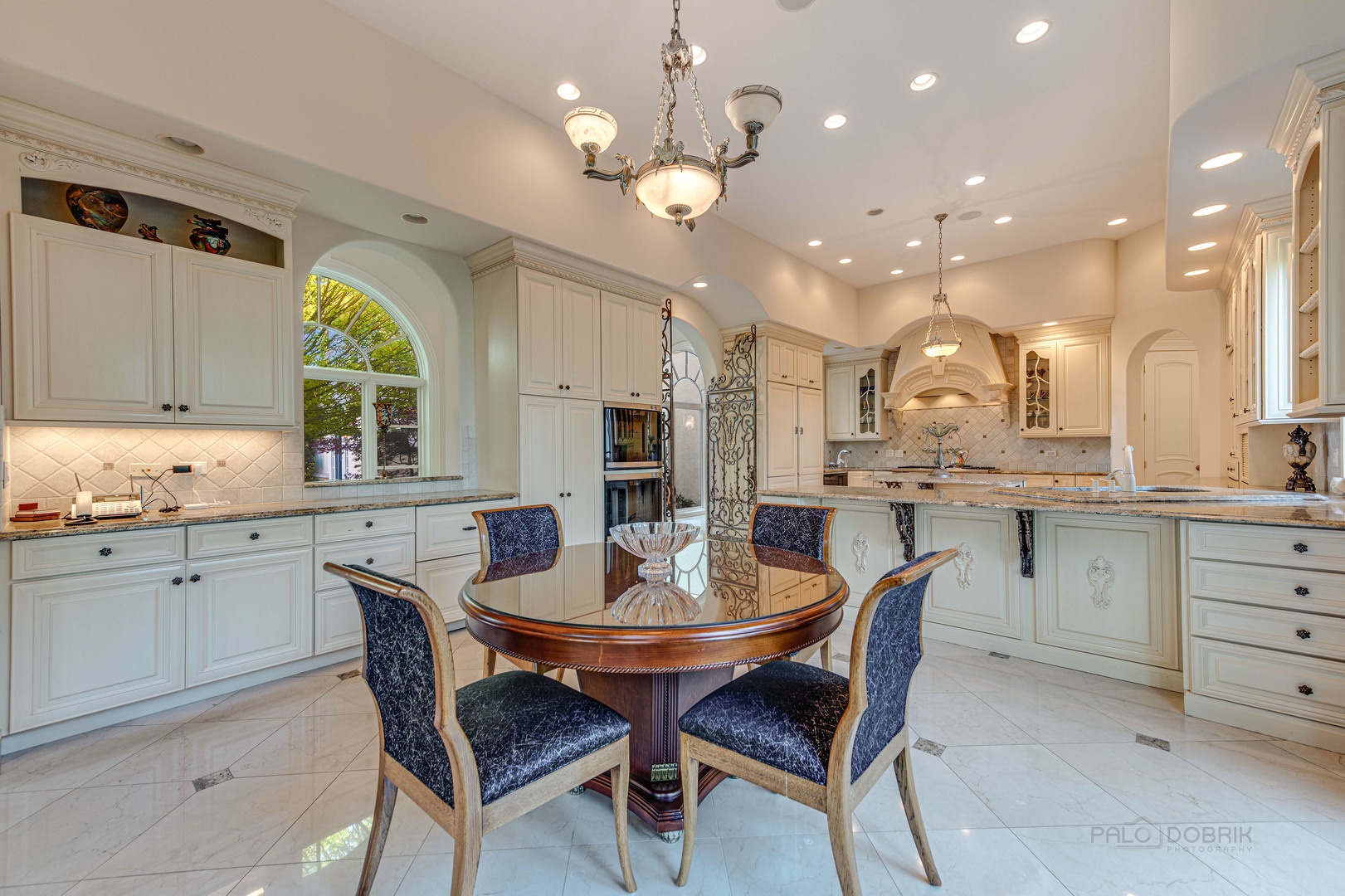 10 West Westleigh Road Lake Forest, IL 60045 - Photo 25 of 59 a kitchen with stainless steel appliances kitchen island granite countertop a table chairs and white cabinets