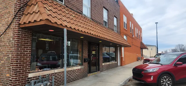a front view of a building with parking space