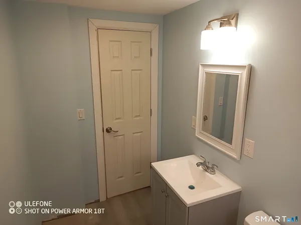 a bathroom with a sink a mirror and vanity