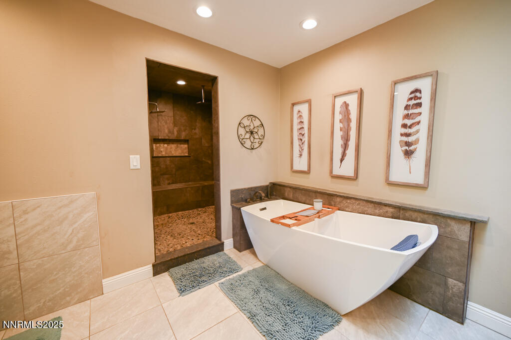 1147 Autumn Hills Road Gardnerville, NV 89460 - Photo 34 of 53 a bathroom with a bathtub and shower