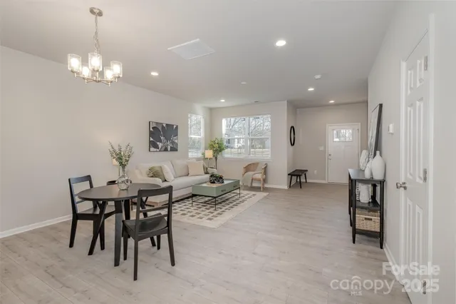 a living room with furniture and view of kitchen