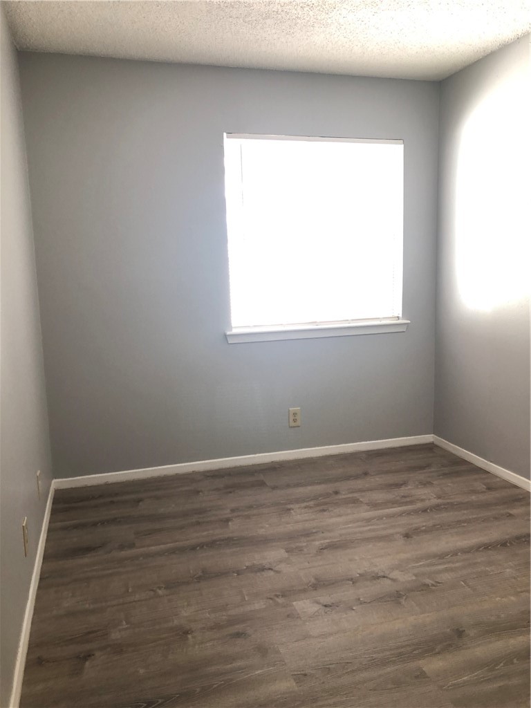 6502 South 1st Street, Unit 102 Austin, TX 78745 - Photo 13 of 26 an empty room with wooden floor and a window