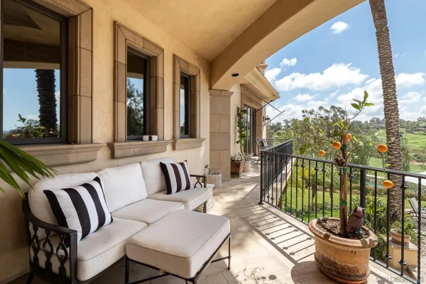 a view of a patio with couches chairs and wooden floor