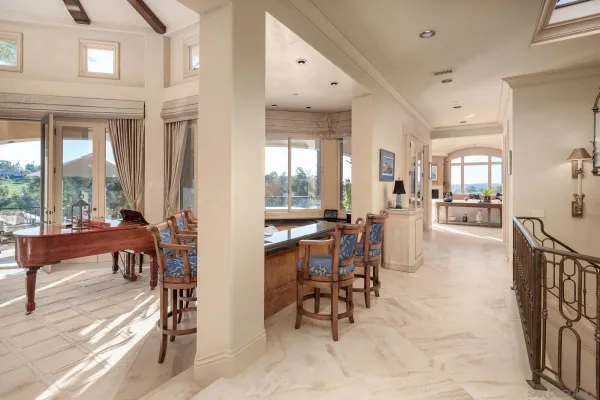 a view of a dining room with furniture and a floor to ceiling window
