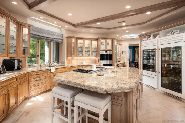 a large kitchen with kitchen island a sink and a stove