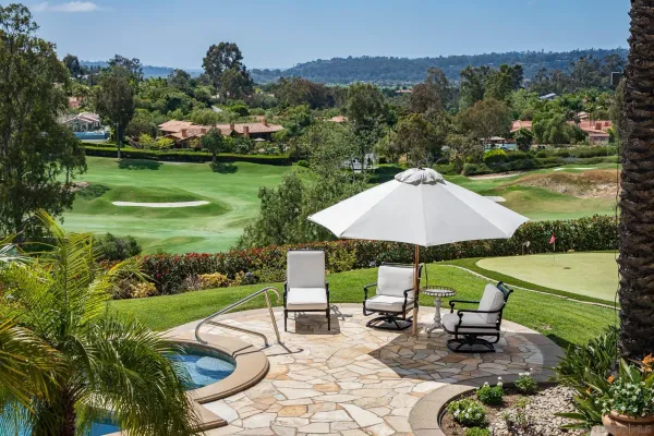 an outdoor space with furniture and garden