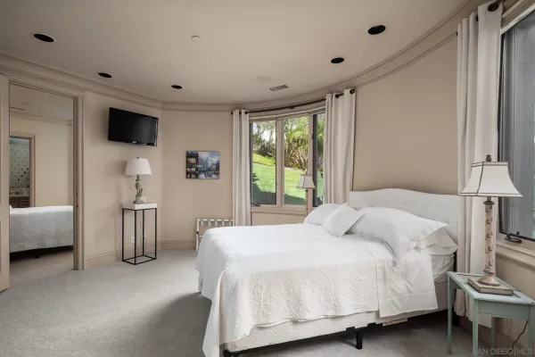 a bedroom with a large bed and a large window