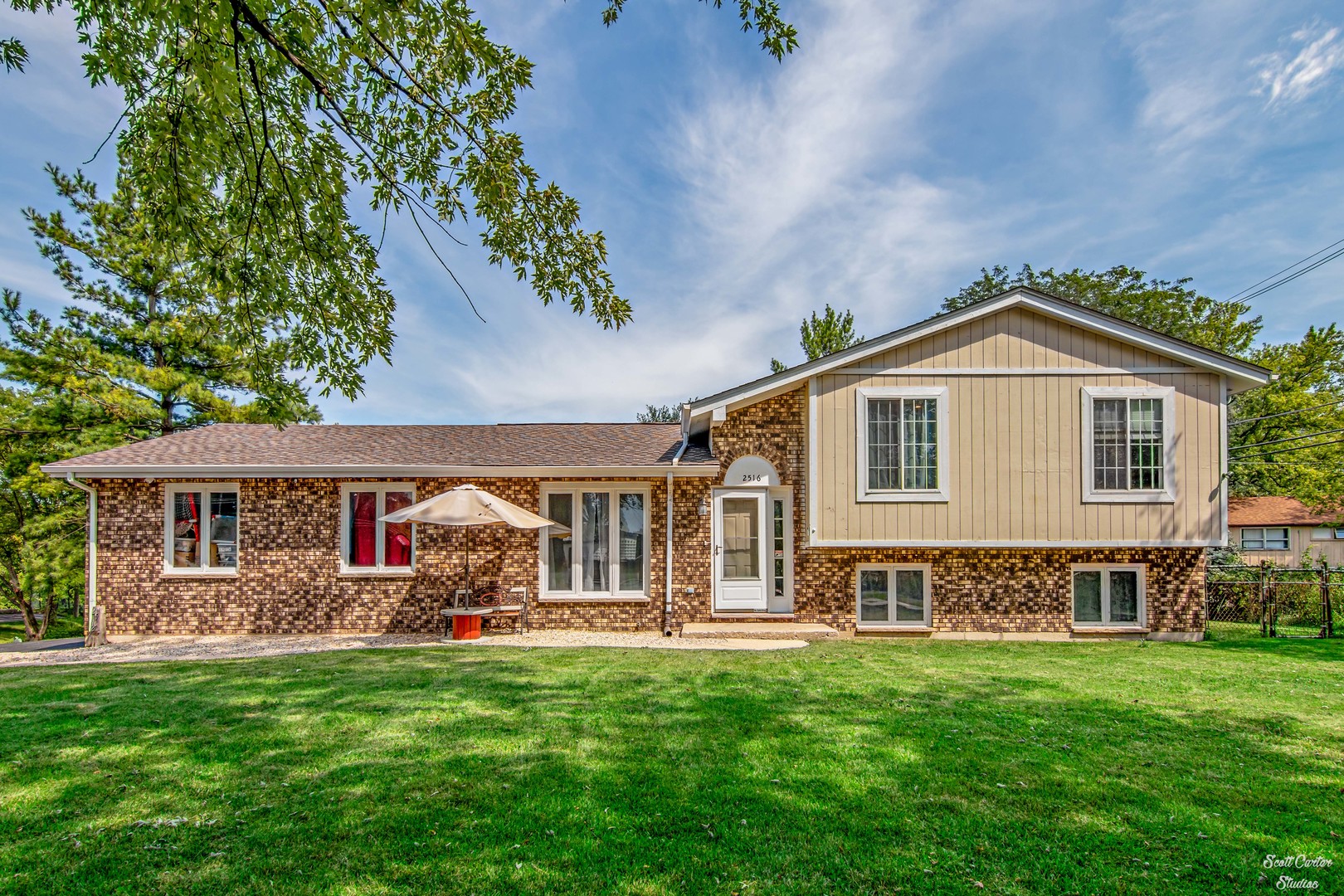 2516 Crystal Lake Road Cary, IL 60013 - Photo 4 of 22 a front view of a house with a garden