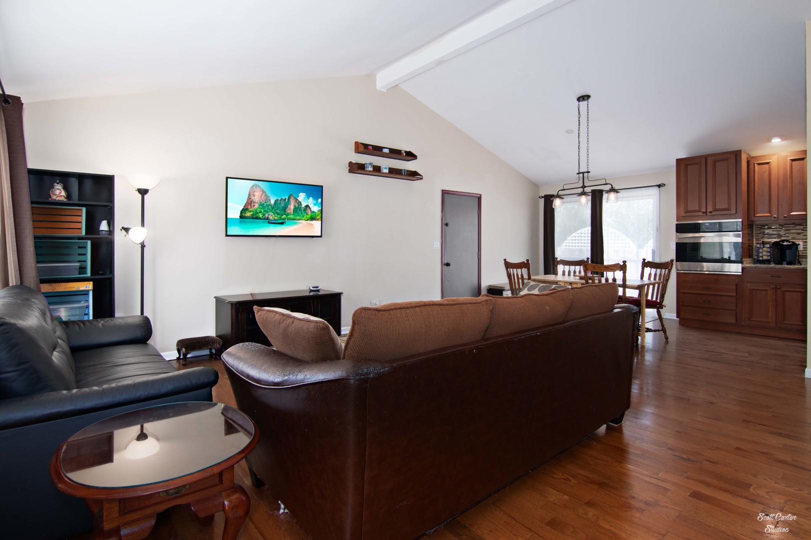 2516 Crystal Lake Road Cary, IL 60013 - Photo 8 of 22 a living room with furniture kitchen view and a wooden floor