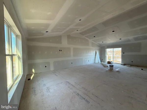 a view of empty room with windows and air conditioner