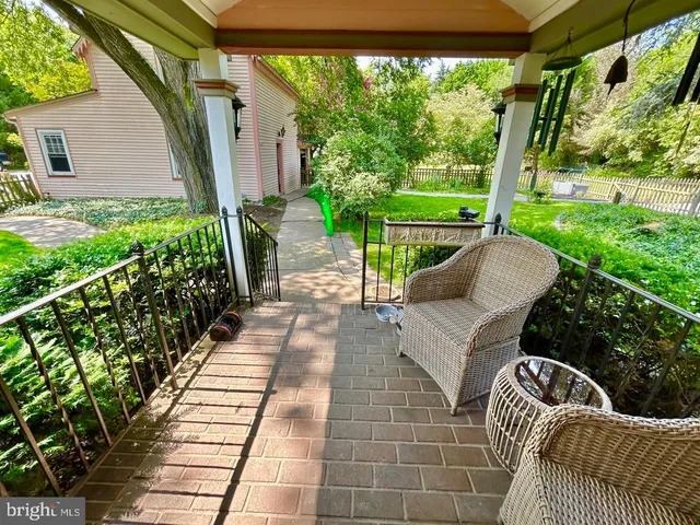 a spacious bedroom with a bed lamp and a dresser